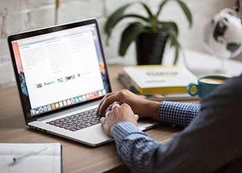 Working at a laptop reviewing business loan options